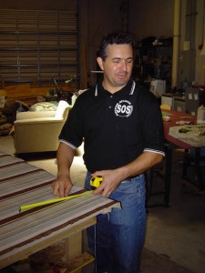SOS boca owner, George, working with a striped fabric for a drapery
